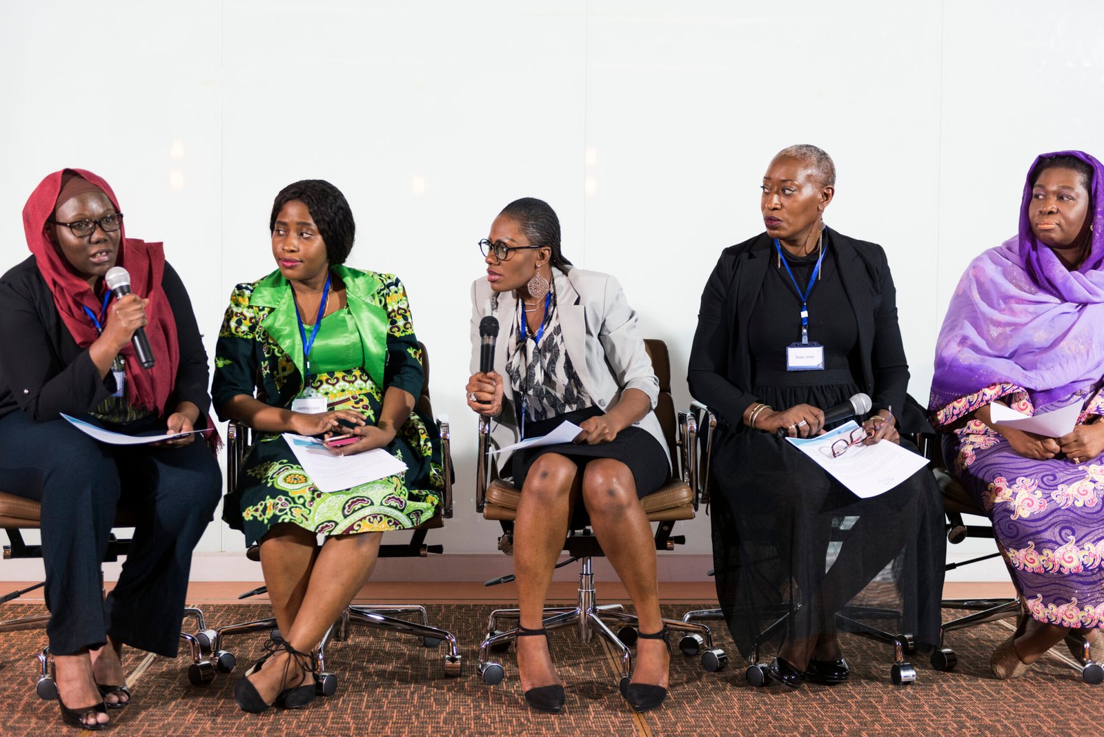 a group of business women participating in a panel discussion