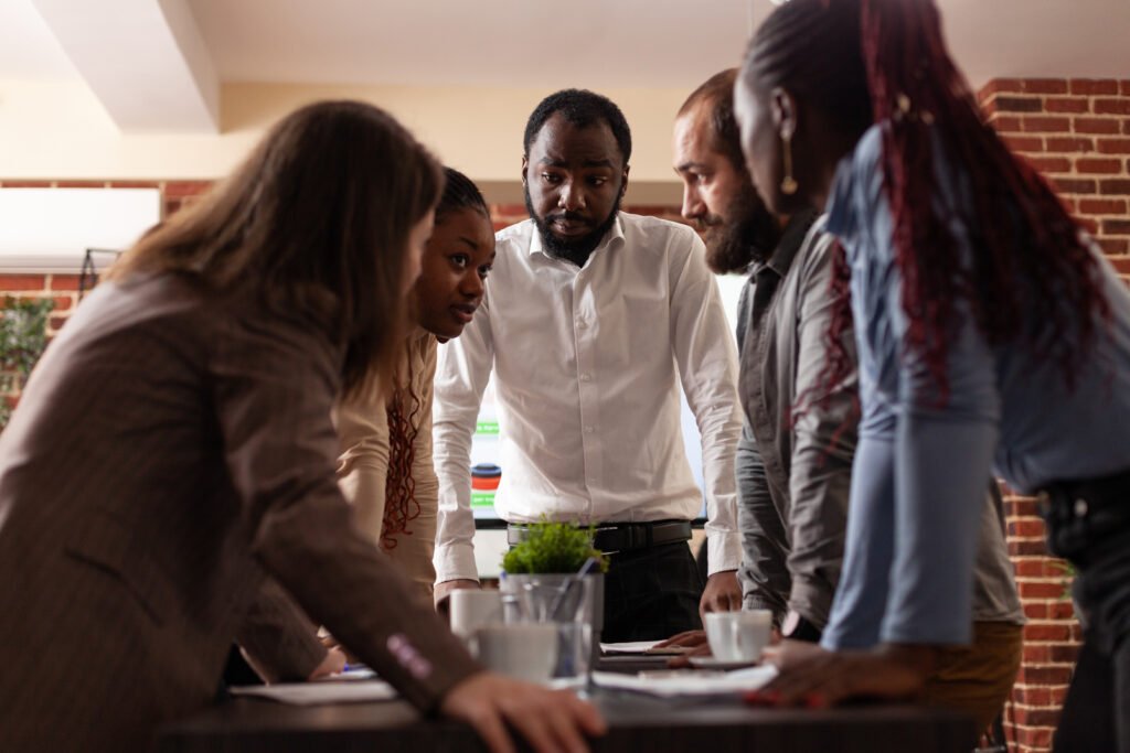 multi ethnic entrepreneurs stand up analyzing financial graph